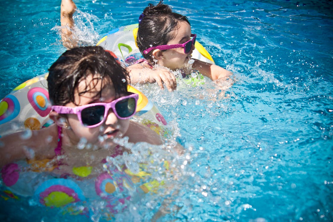 young children playing in pool