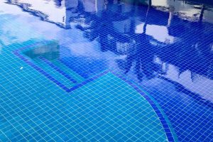 The surface of a deep blue pool