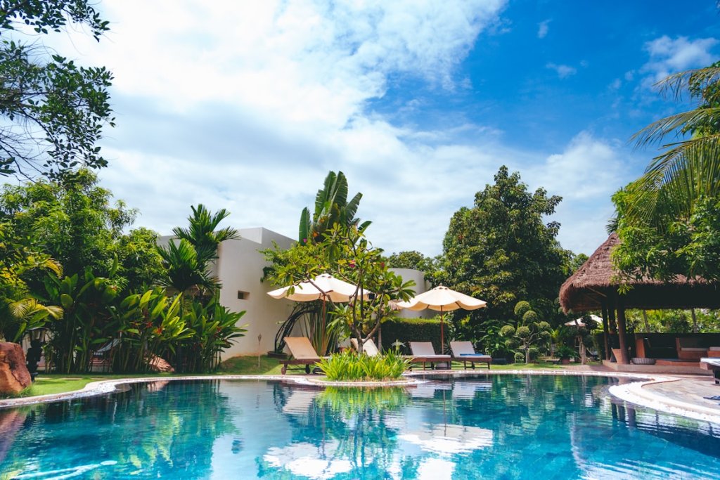 A tropical appearing poolside with bright blue skies and waters