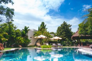 A tropical appearing poolside with bright blue skies and waters